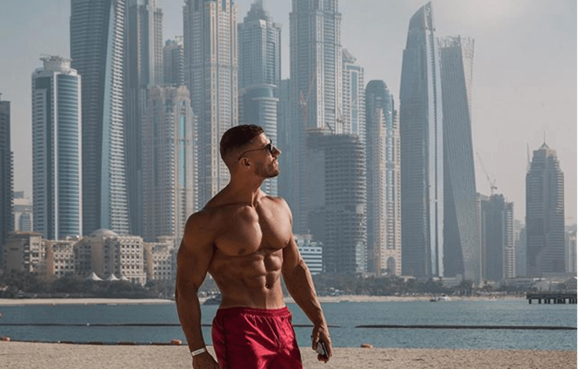 Mike Thurston In Front Of Dubai Skyline On Beach